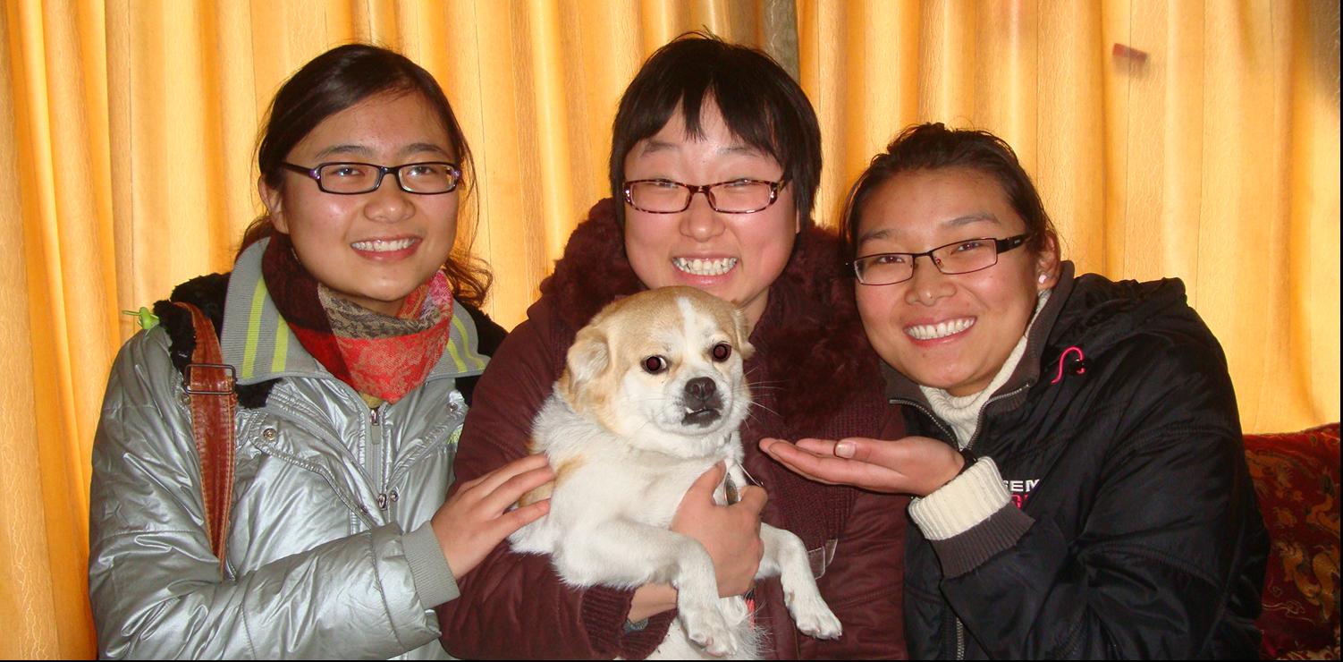 Picture:  Panda, holding GouGou,  flanked by our Tibetan dog sitters.  Jiangnan University, Wuxi, China