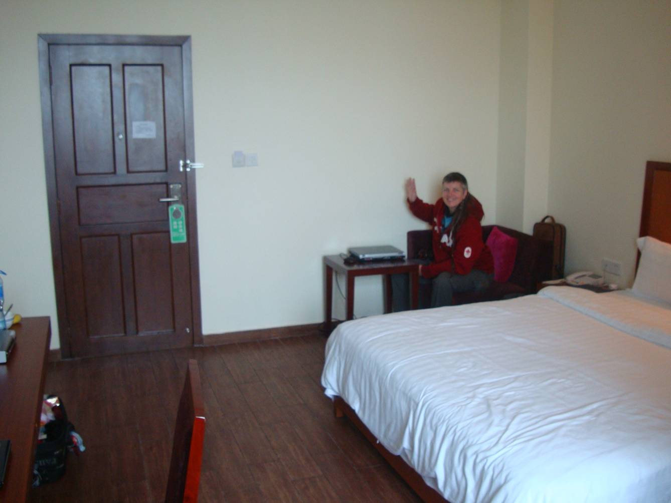 Picture:  Ruth waves from her station at the laptop in our hotel room.  Haikou on Hainan Island, China