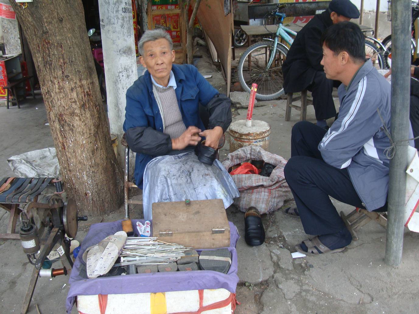 Picture:  Shoe repair and shoe shines on the streets of Haikou, Hainan Island, China