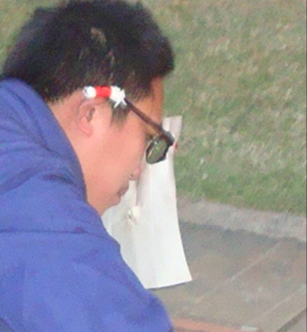 Picture:  A welder wearing makeshift face protection - a piece of paper hung on a pair of sun glasses.  Haikou on Hainan Island, China