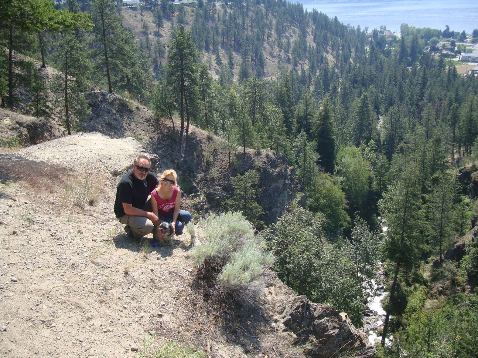 Les and Sheila and Buster the affection sponge dog.  On a hike near Peachland, B.C.