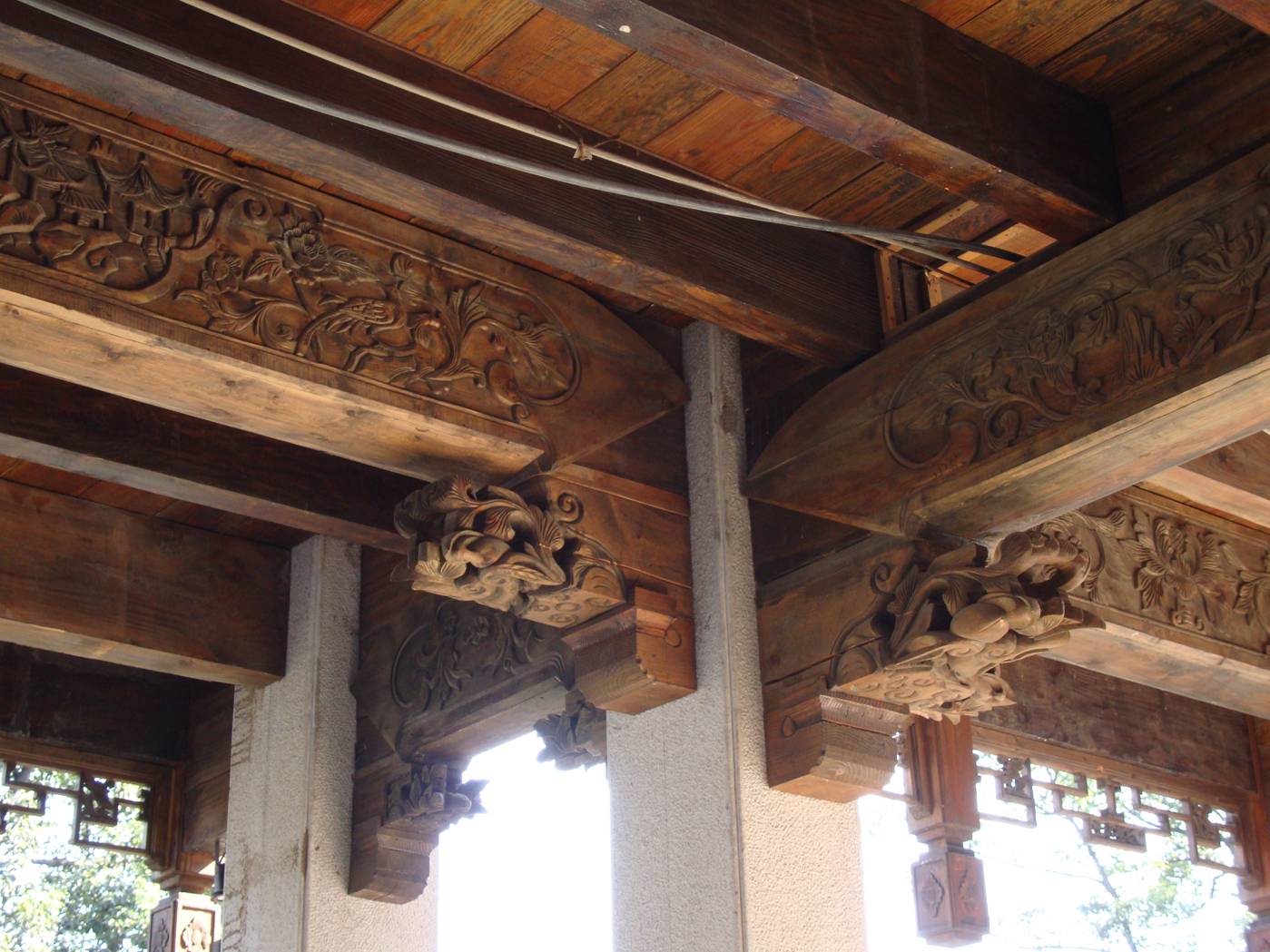 Picture:  Above her head, this elaborate classical post and beam ceiling.  Wuxi old city, Wuxi, China