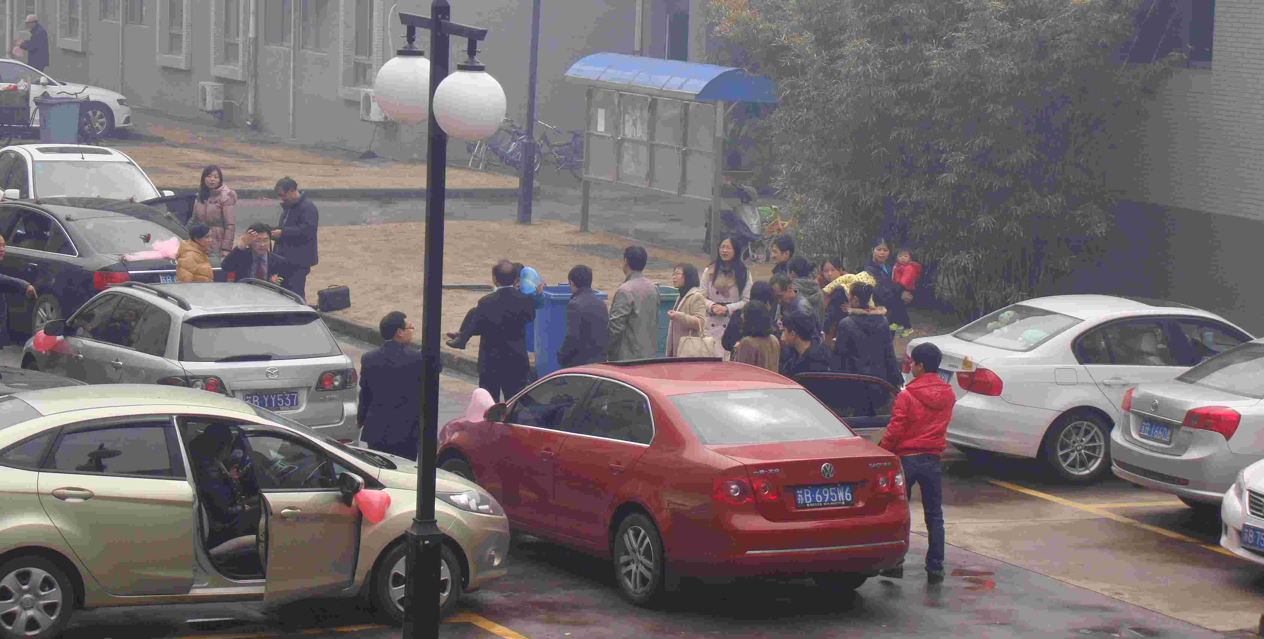 Picture:  Early morning and the wedding party gathers outside our apartment building.  Jiangnan University, Wuxi, China