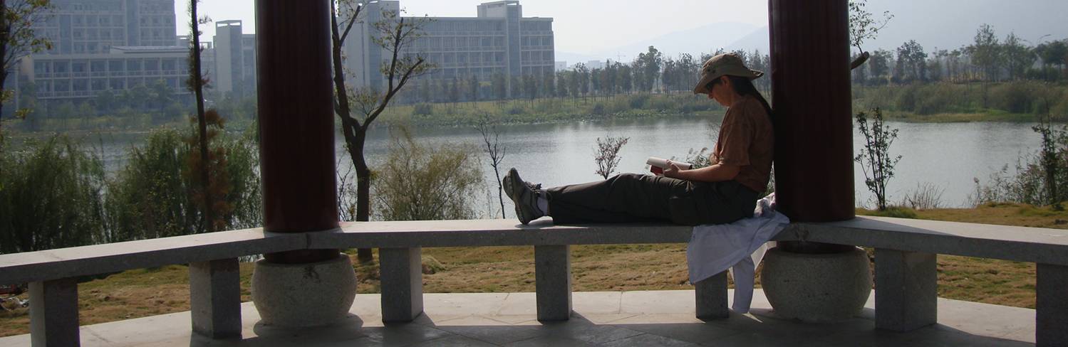 In the new pavilion on the peninsula, Ruth enjoys the last warm weather while letting the dog run loose.  Jiangnan University, Wuxi, China