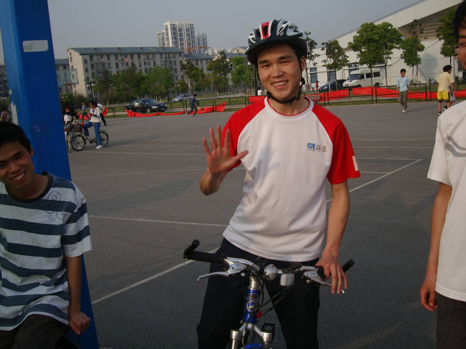 Bike club member shows off essential head gear.  Earth Day at Jiangnan University,  Wuxi,  China