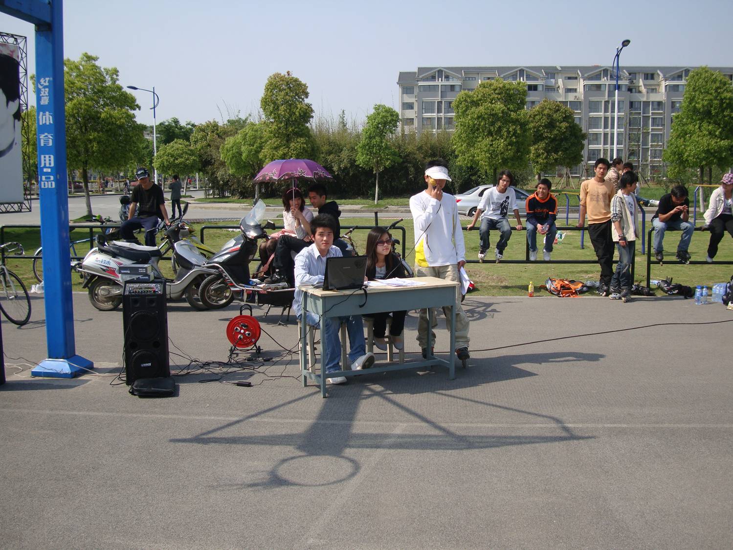 The announcers at the rollerblading competition.  Jiangnan University,  Wuxi,  China.  Once we figured out how to cut the reverb,  you could understand them.