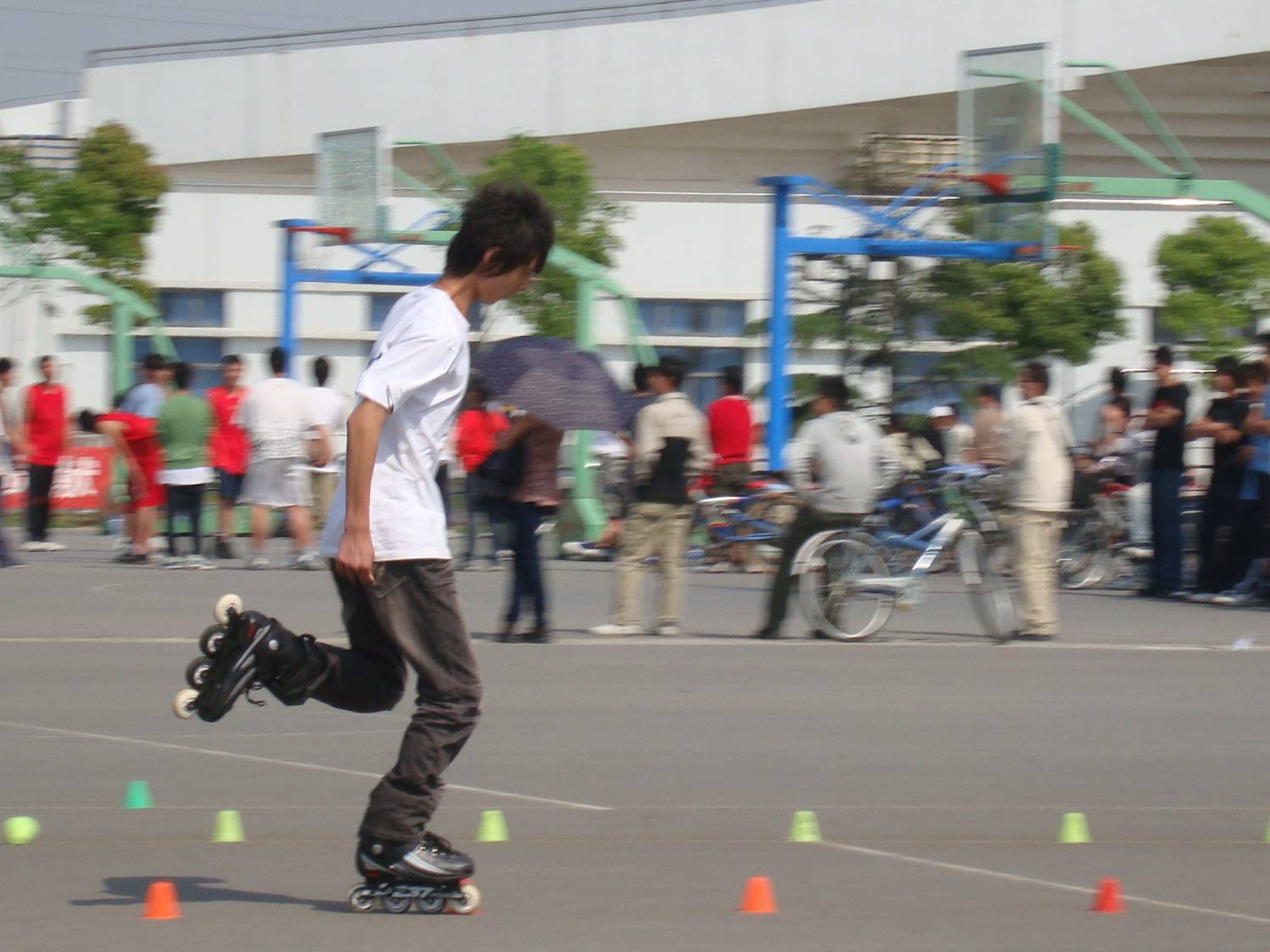 That foot is in the air for the whole run through the cones.  Amazing.  Rollerblading competition at Juangnan University,  Wuxi,  China