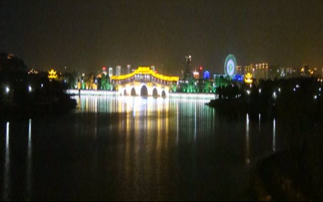 Picture:  The pedestrian bridge with the ferris wheel a mile or two in the background, reflected in the waters of Tai Hu.  Wuxi, China