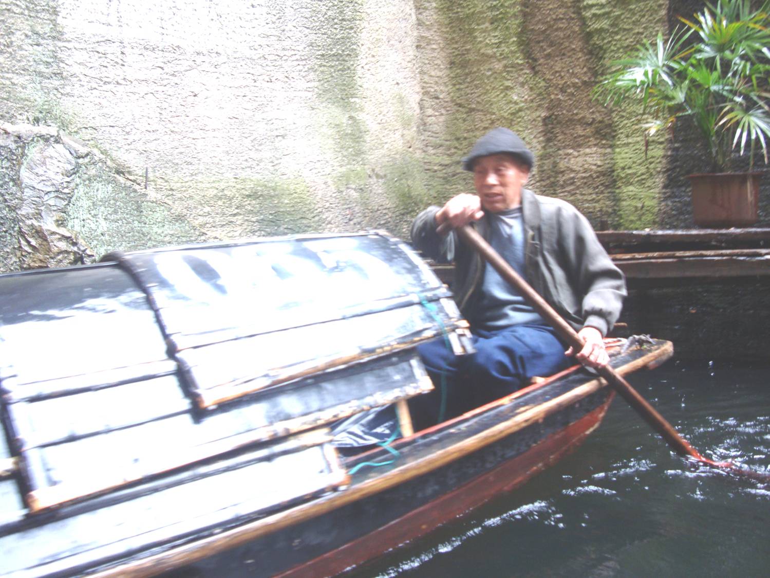 Picture:  The boatman in his traditional felt hat is actually paddling with his feet.  He only uses the paddle to steer, and he can really move that boat.  Donghu, Shaoxing, China