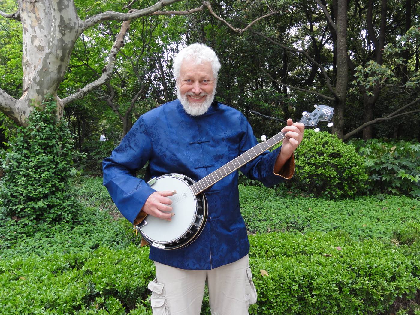 Picture:  Me and my new banjo.  People's Square Park in Shanghai is beautiful once you get away from the crowds.