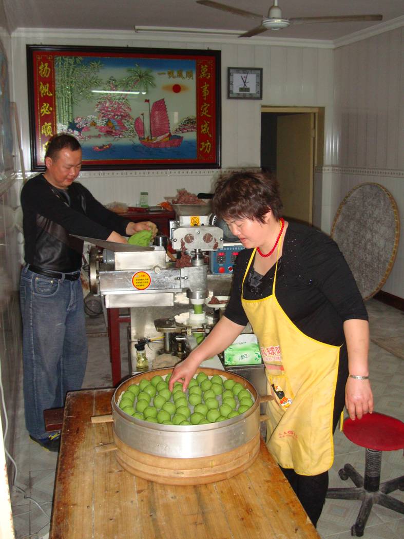 Picture: The owner and his wife work the tuanzi maker.  Yang Shan, Wuxi, China