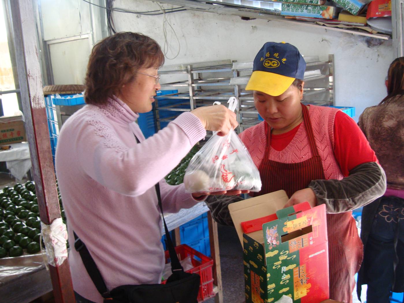 Picture:  And Mrs. Zhu is not one to let us leave without a gift of the treats.  Yang Shan, Wuxi, China