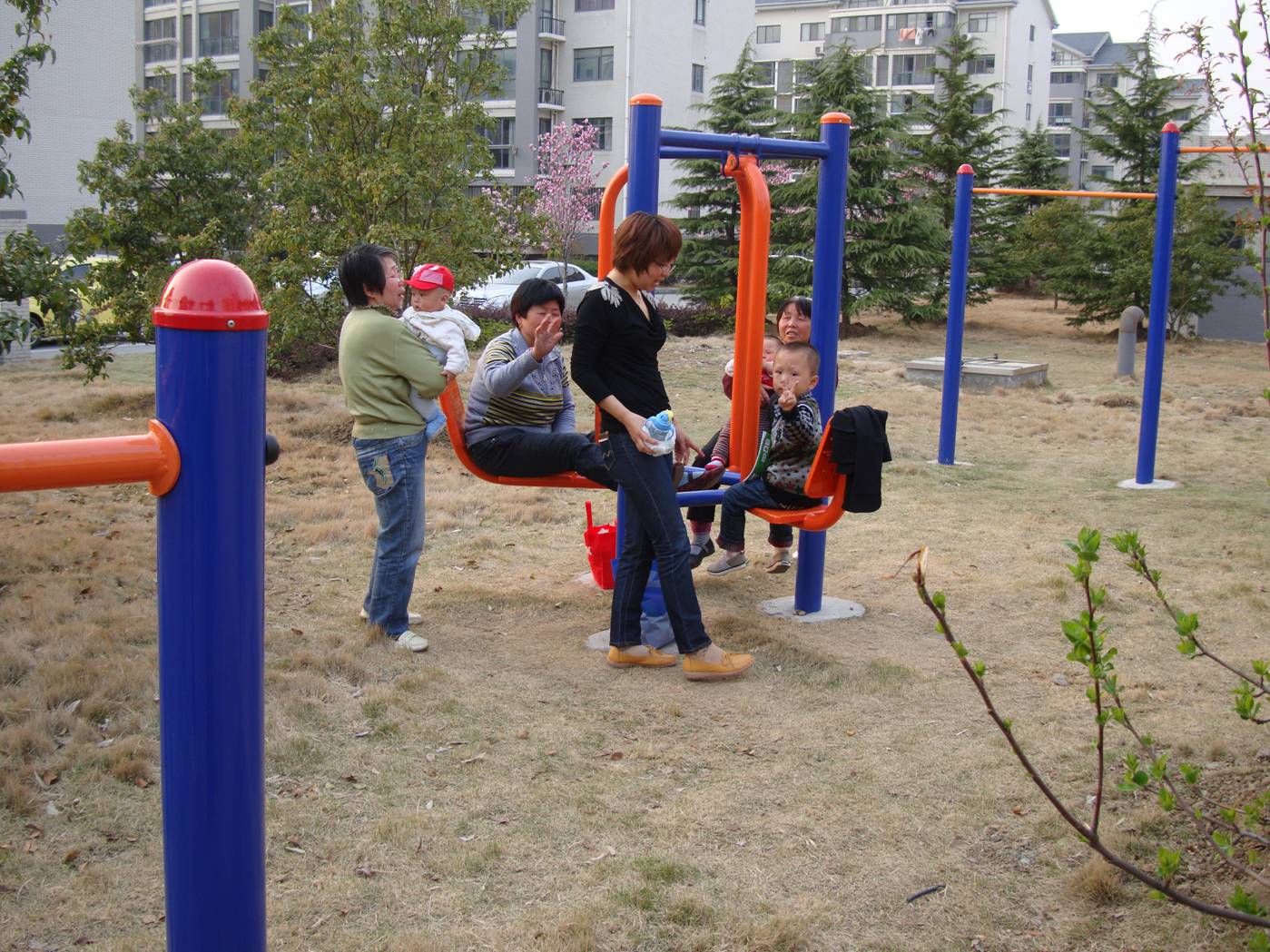 Picture:  Grandmothers and moms and kids enjoy the equipment in the new playground behind our apartment.  Jiangnan University, Wuxi, China