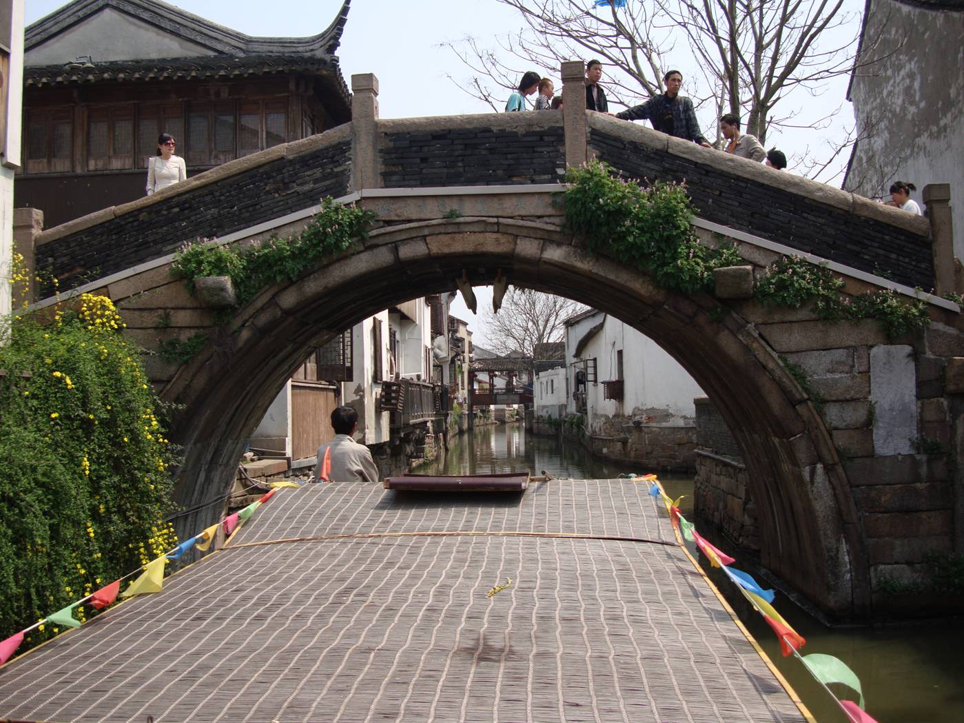 Picture:  Our canal tour boat goes under an old pedestrian bridge.  Suzhou, China