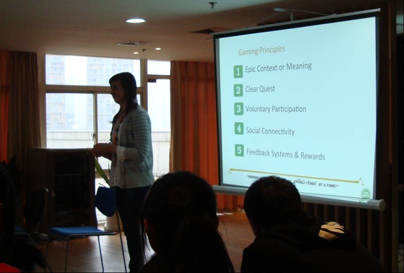 Picture:  Talis describes the principles of computer games that can be applied to volunteering.  Wuxi, China