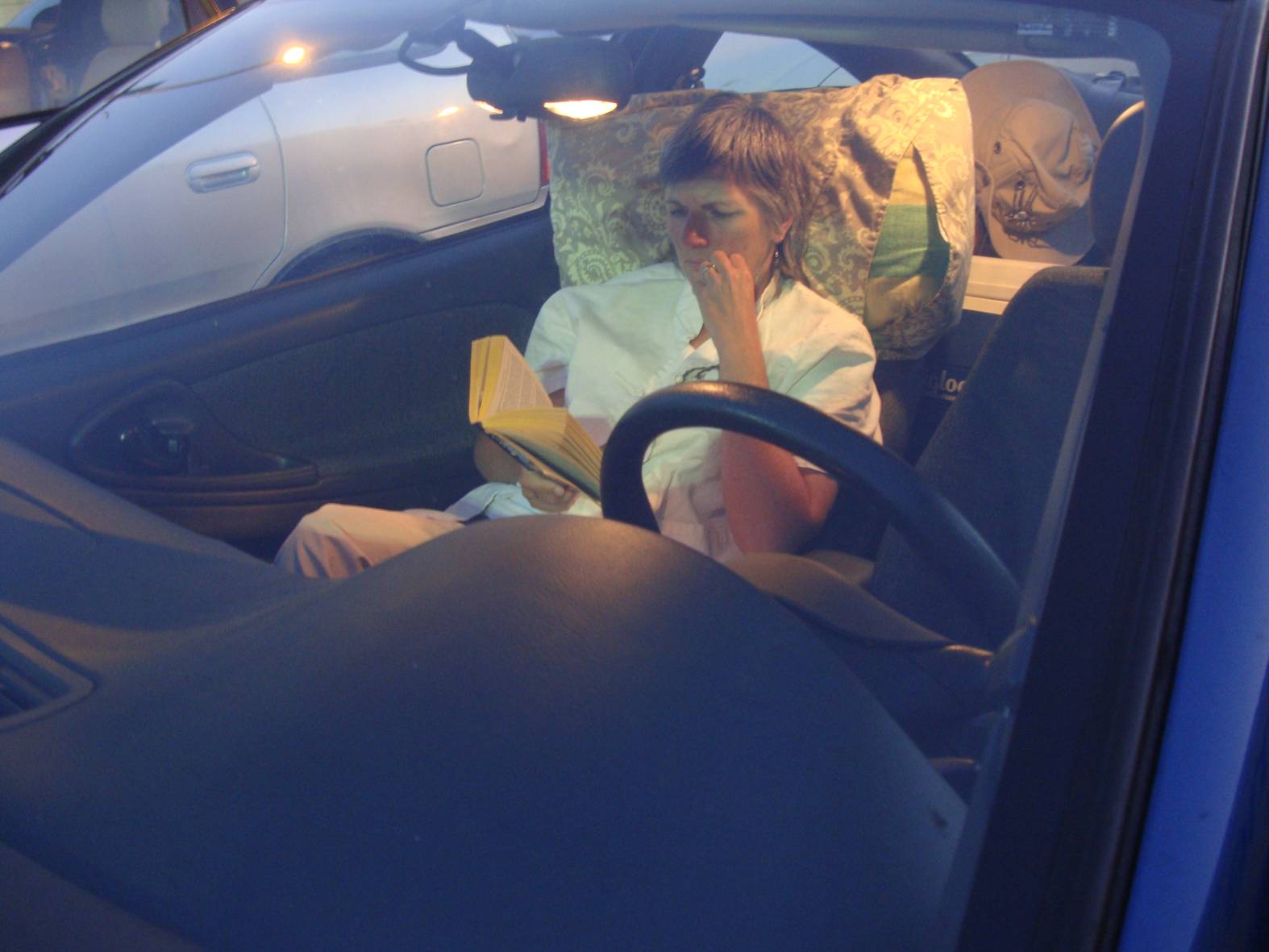 picture: Ruth reads her SF in the car while waiting for the ferry back to the mainland.