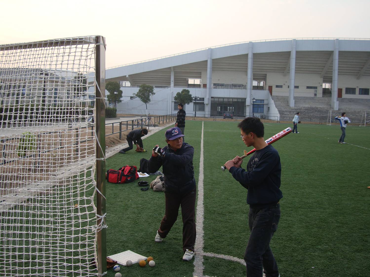 And this is how you swing.  Softball coaching, Jiangnan University,  Wuxi, China