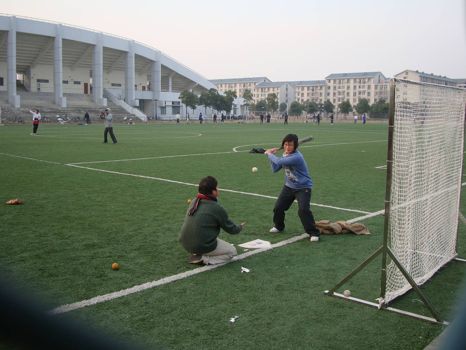 I don't remember being taught to swing a bat, so it seems strange to me that it might need training.  Softball coaching, Jiangnan University, Wuxi, China