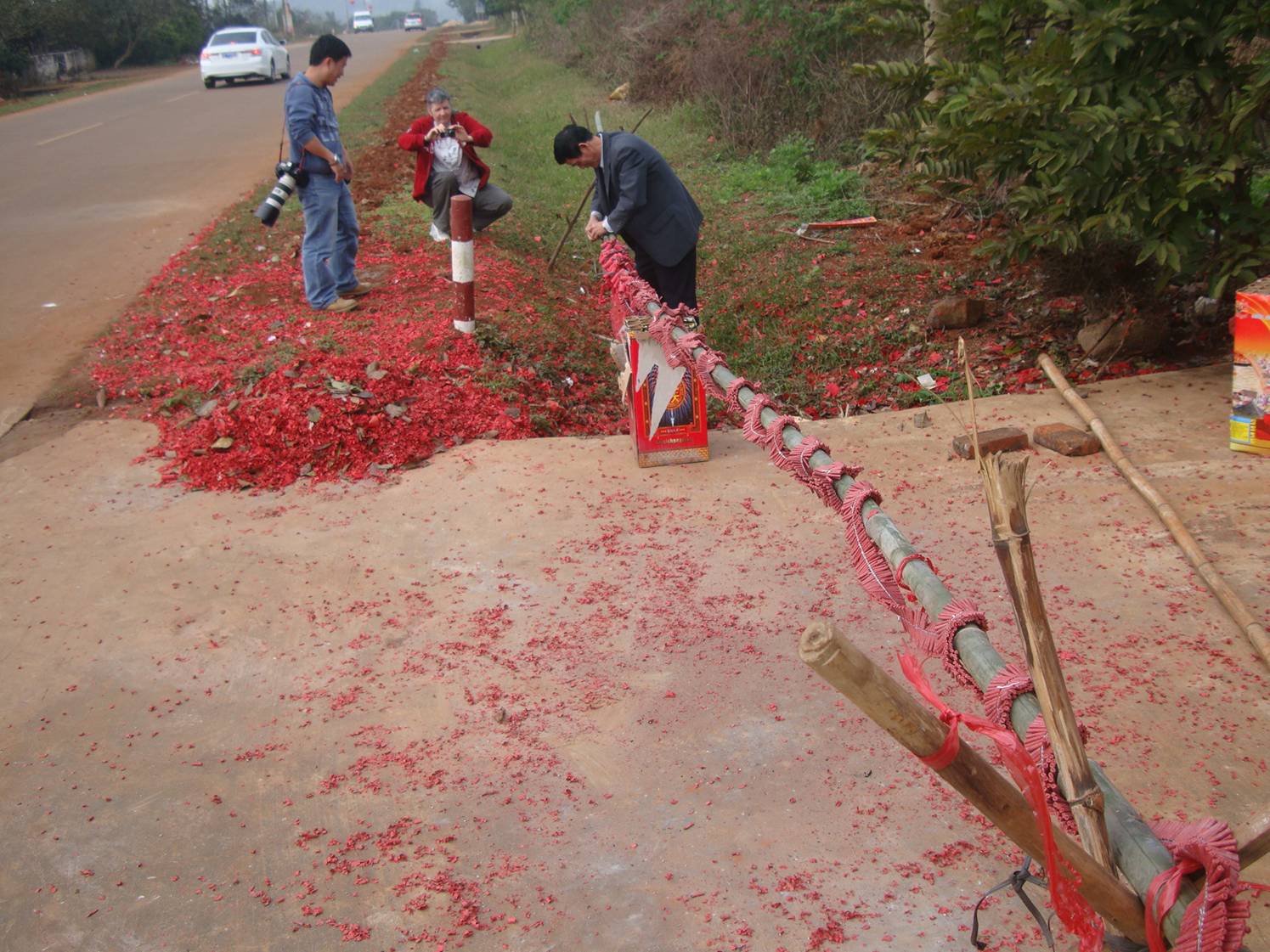 Picture:  Xiao Hua's father and Jack Zhang set up the fireworks.  Yan Feng village, near Haikou on Hainan Island, China