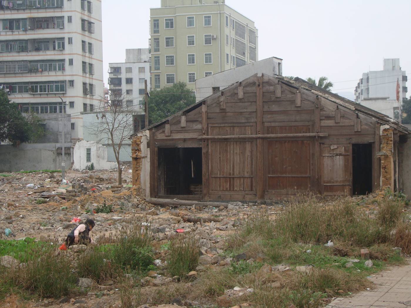 Picture: The old farm building, a sad remnant of an agricultural lifestyle now lost to and surrounded by urbanization.  Haikou, Hainan Island, China