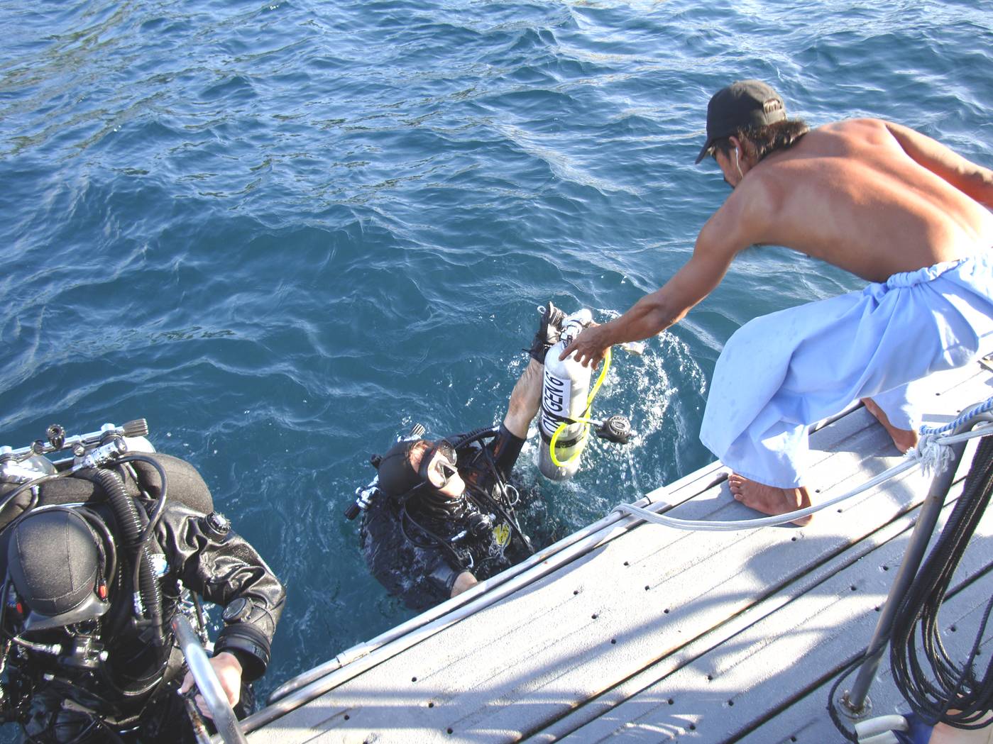 Picture:  Doug helped out of the water after his dive.  Phuket Island, Thailand.