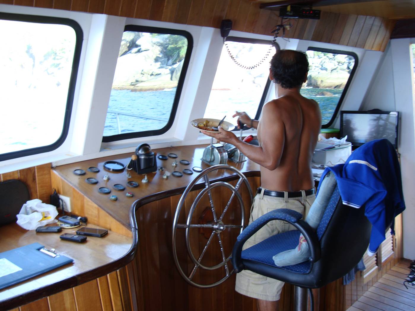 Picture:  The captain enjoys his lunch between dive spots.  Dive Asia out of Phuket Island, Thailand