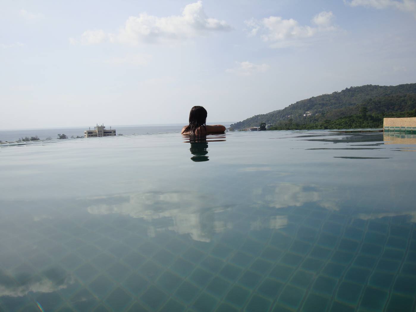 Picture:  Naam contemplates infinity in the infinity pool on the roof of the villa.  Karon Beach, Phuket Island, Thailand