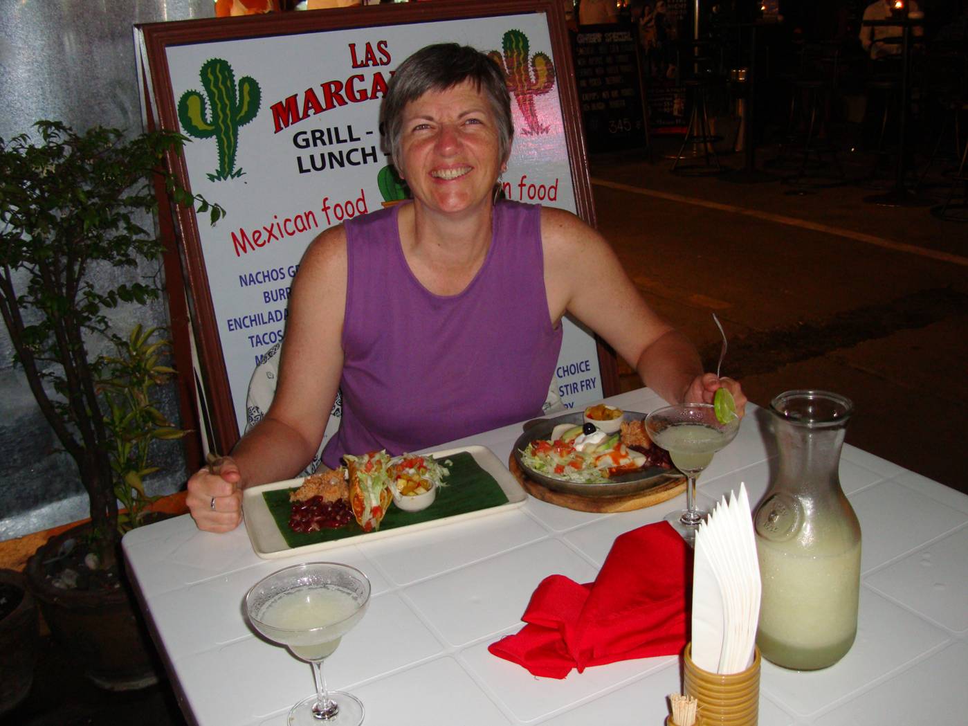 Picture:  Ruth enjoys sharing our last pitcher of margaritas.  Phuket Island, Thailand