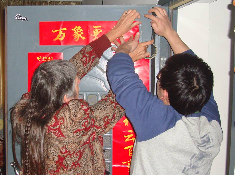 Ruth and Wang Yijing decorate our door in the traditional fashion.  Jiangnan University, Wuxi, China