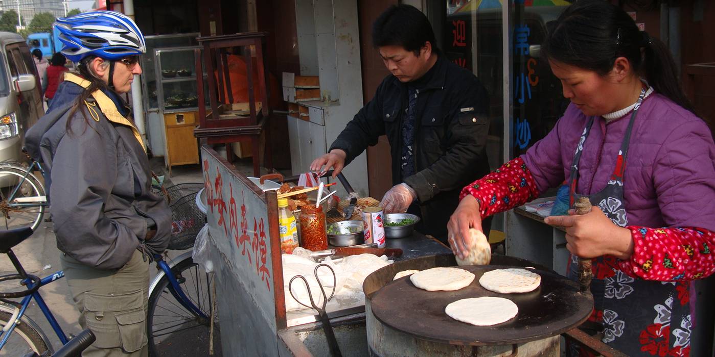 Ruth waits for the delicious pita pocket street food, Wuxi, China