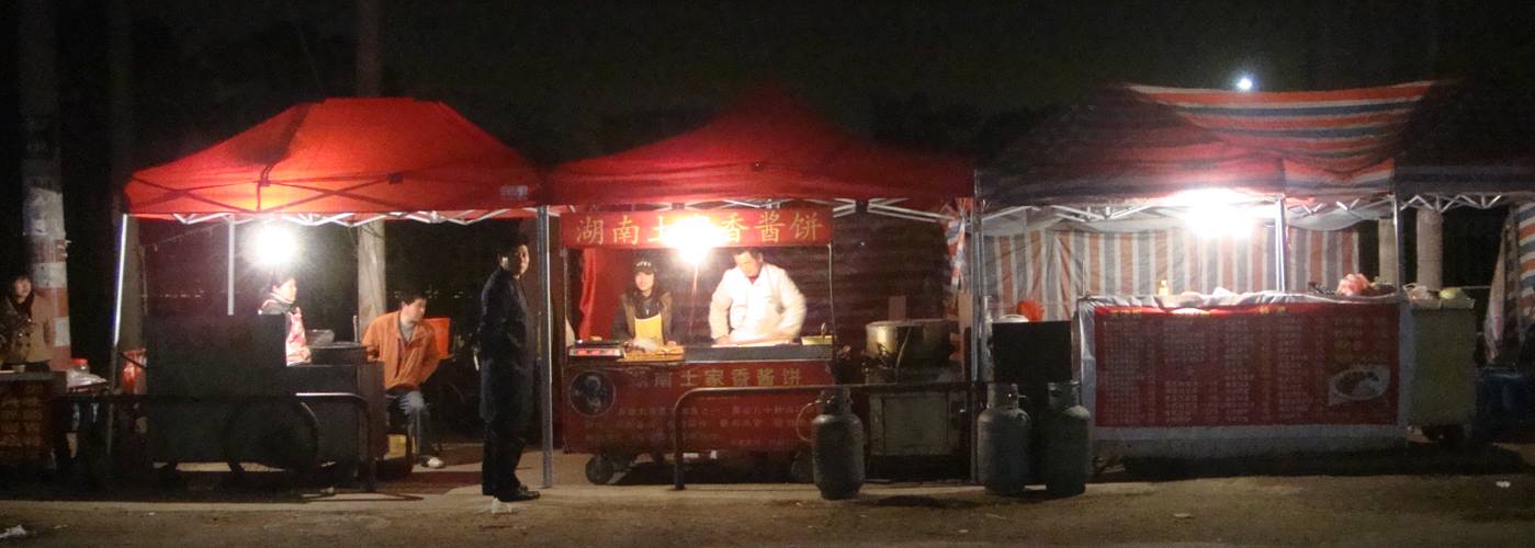 Picture:  Instant restaurants on Shi Tang Jie.  My friend Jackie and I have begun our investigation of street sellers.  Fascinating subject.  Shi Tang Cun, Wuxi, Jiangsu, China