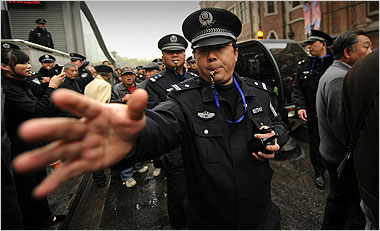 Policemen breaking up crowds in Shanghai on Feb. 27 after anonymous calls for protests circulated on the Internet. Picture stolen from the NT Times.