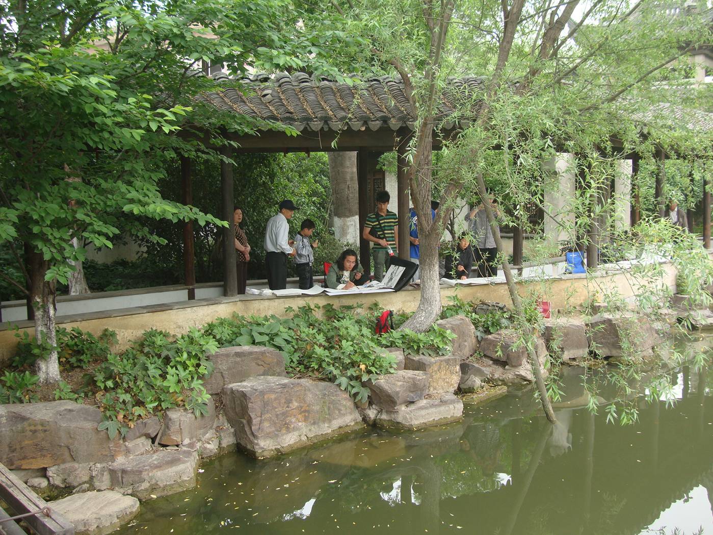 Picture:  Painters at work at the pond on the grounds of the museum outside Xi Hui Park, Wuxi, China