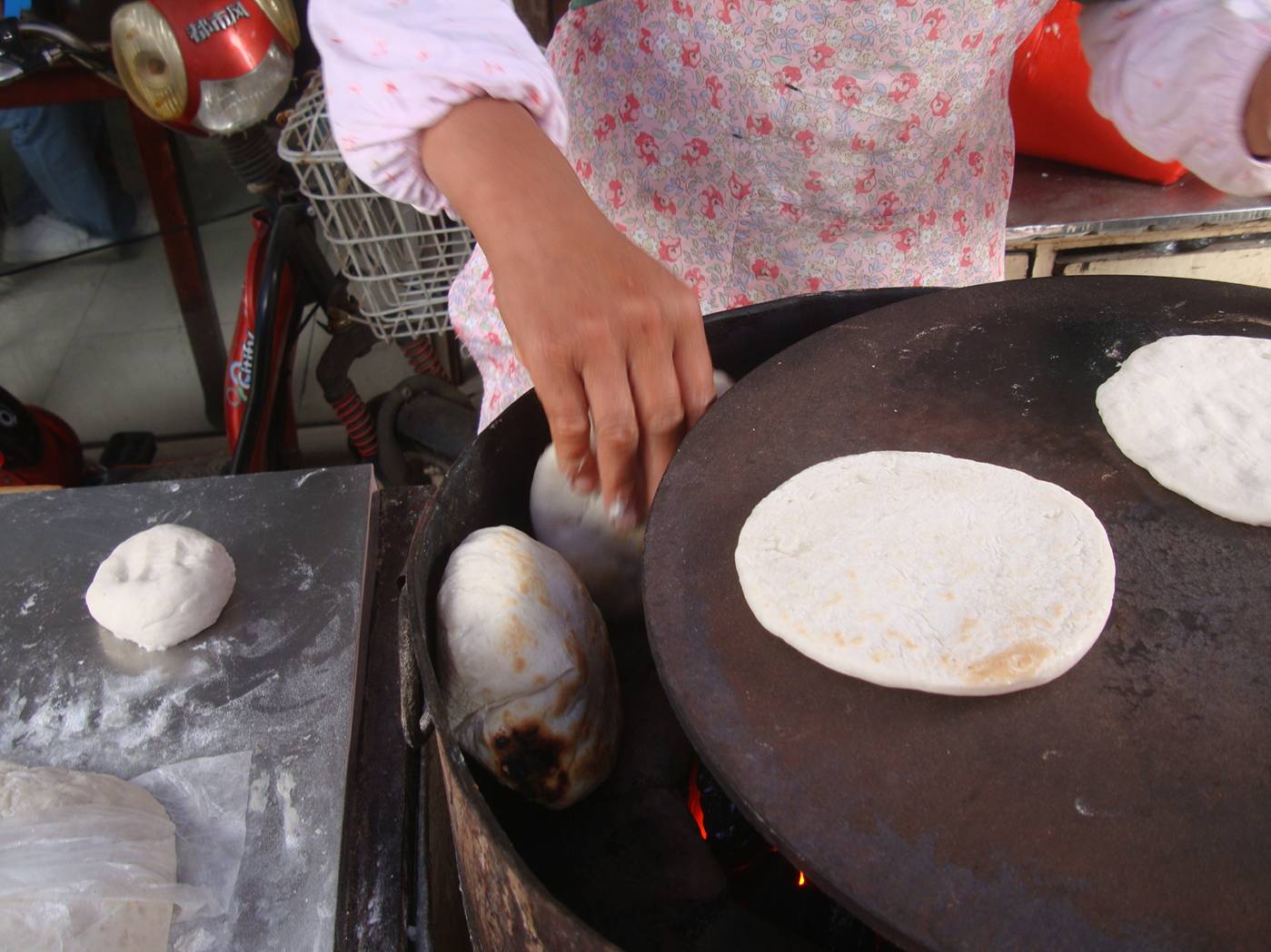 Picture:  I'm fascinated by this oven, a converted oil barrel lined with bricks and fired with charcoal, with a flat top to seal the crust before baking.  Shi Tang Cun, Wuxi, China