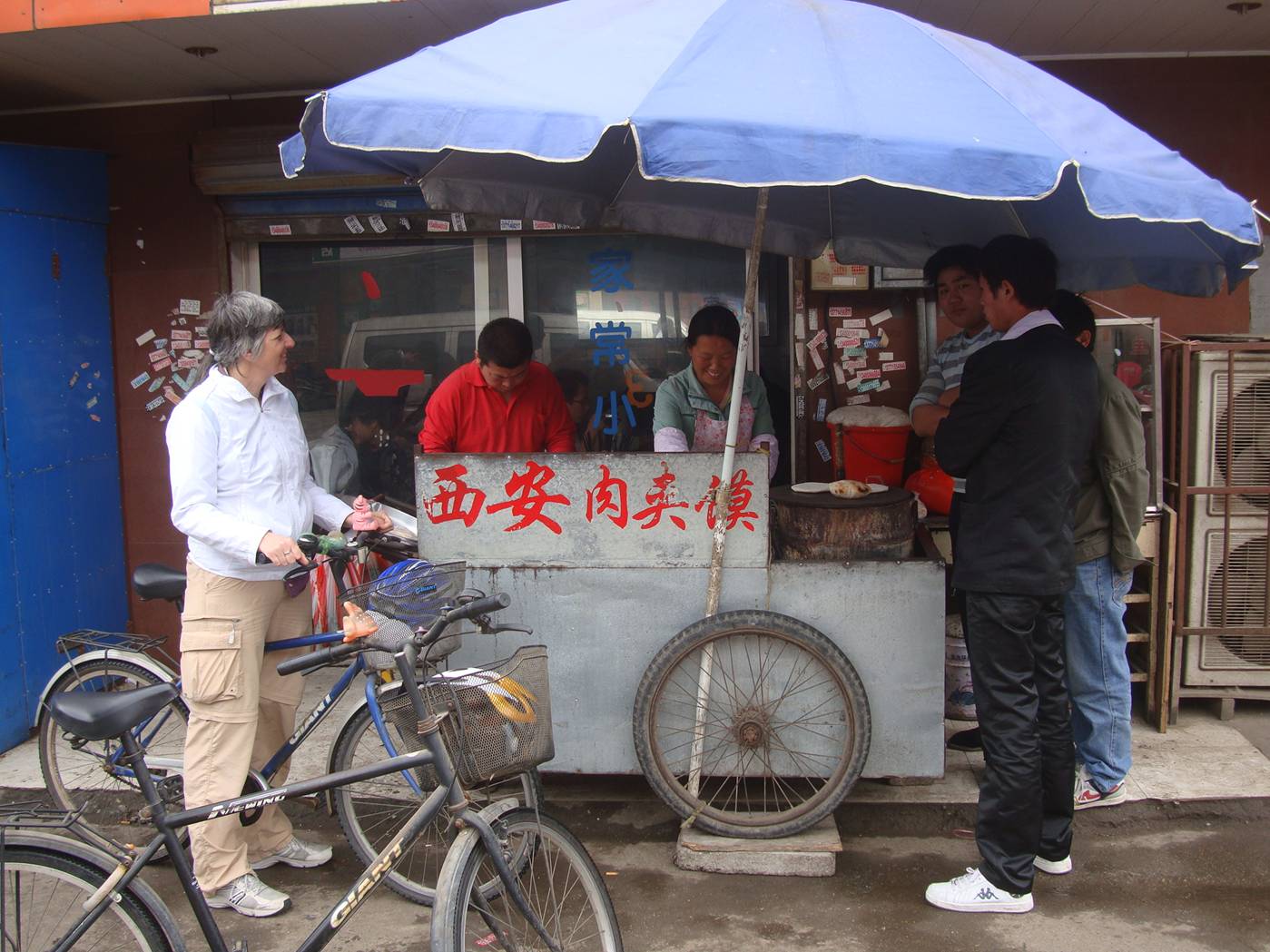 Picture:  Ruth waits for our favourite street food.  Shi Tang Cun, Wuxi, China