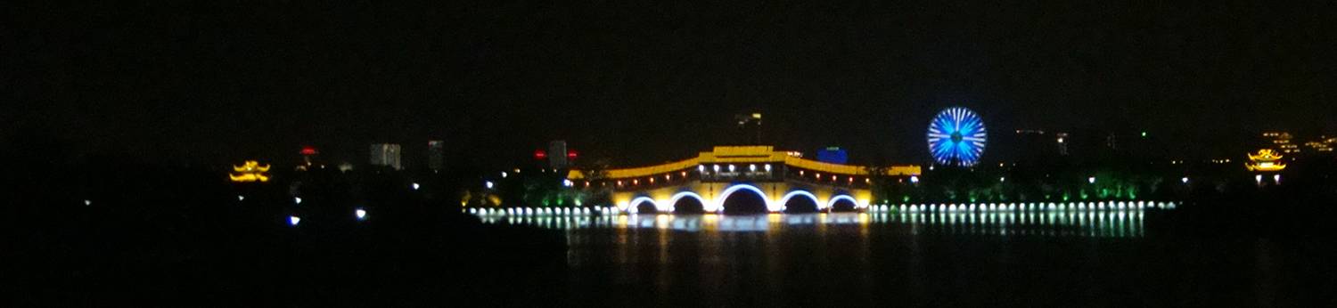 The new footbridge joining the lakeside parks, with the big Japanese made Ferris wheel in the background.  Wuxi, China