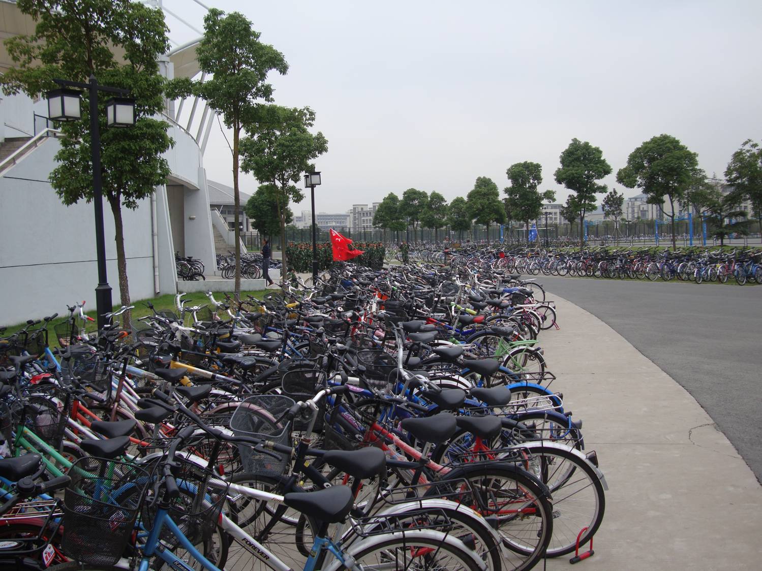 Look past the sea of bikes, and you see the freshmen in marching formation.  Jiangnan University, Wuxi, China