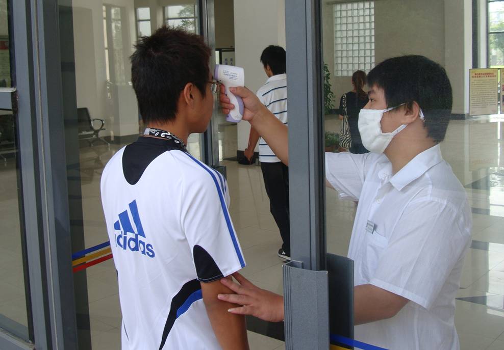  Taking a student's temperature before classes.  H1N1 precautions at Jiangnan University, Wuxi, China